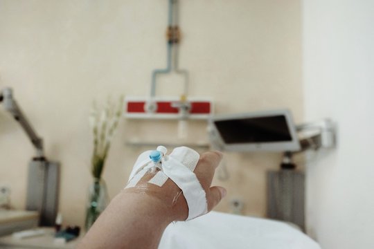 Patient with branula in his hand