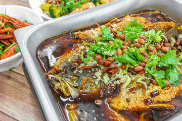 Sichuan Grilled Fish in red spicy oil. Authentic China Chinese Szechuan Chongqing food on table.