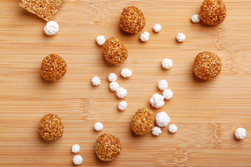 Til Gul OR Sweet Sesame Laddu with Fikri for Indian festival Makar Sankranti over wooden background 