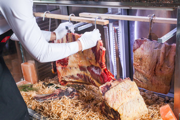 Display of Dry Aged Meat Steaks in butchers shop or restaurant in an display refrigerator.