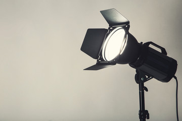 Studio lighting with tripod on black background