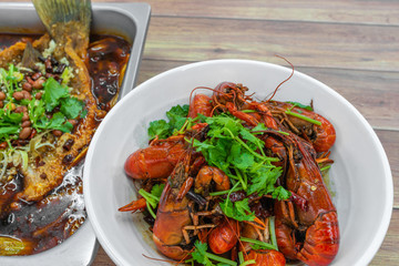 Chongqing Sichuan spicy dried chilli small lobsters, and Chongqing grilled dish. Chinese Food photography at Chinese restaurant.