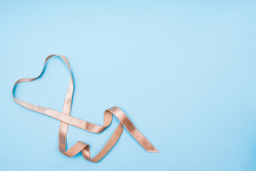 pastel coloured heart on blue background with copy space