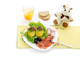 Children's meal - stuffed with potatoes, vegetables and bacon on the table close-up