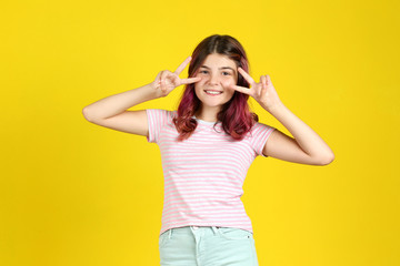 Fototapeta na wymiar Beautiful young girl on yellow background