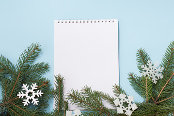 Winter wish list with christmas decor on blue background, copyspace