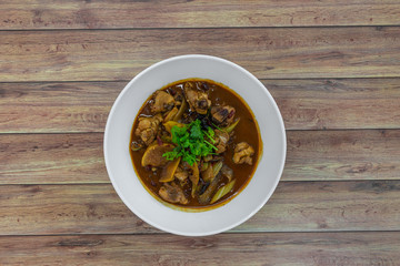 Stir-fry spicy chicken with sliced potato and dried chillies. Authentic China Chinese Sichuan food on table.