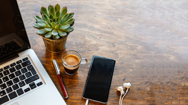 Workplace. Computer Laptop And Mobile Phone On A Wood Office Desk