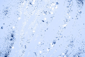 confetti and stars and sparkles on Classic Blue Christmas background. Top view, flat lay. Copyspace...