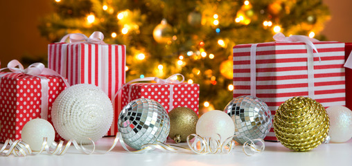 Christmas presents and balls against the backdrop of a Christmas tree