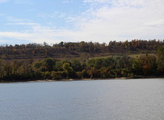 A beautiful view of the river and the grass hill landscape.