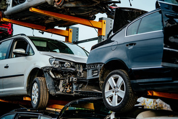 Damaged cars waiting in a scrapyard to be recycled or used for spare parts