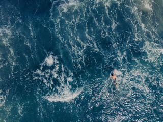 Aerial view to ocean waves. Blue water background