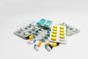 Numerous drug in different beautiful capsule color, Some drug is in package, isolated on the white...