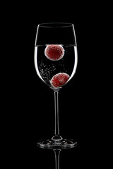 glass of water with grapes and bubbles