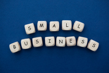 Small business words cubes abstract lettering, blue background.