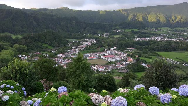 Furnas Valley and town from the observation desk with hortensia flowers. Azores, Portugal