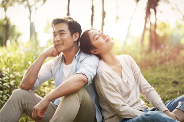 young asian couple relaxing in park