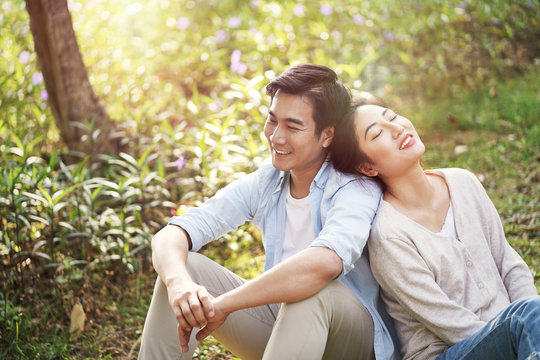 young asian couple enjoying nature outdoors