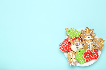 Christmas gingerbread cookies in plate on blue background
