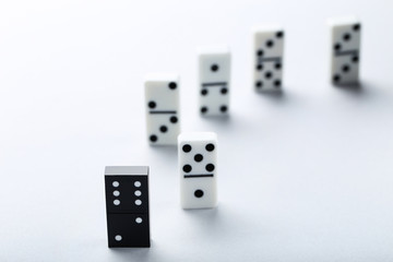 Leader concept. Domino tiles on grey background