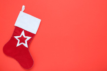 Red christmas stocking on red background