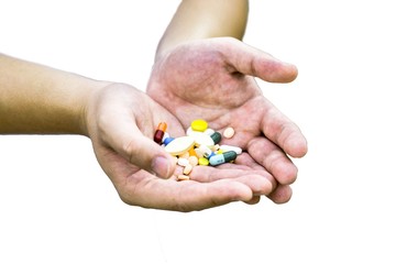 hand with pills isolated on white