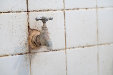 old rusty water tap in the india toilet