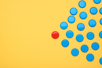 Fototapeta premium Bottle caps leader on yellow background