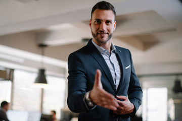 Fototapeta premium Businessman gives a hand for handshaking 