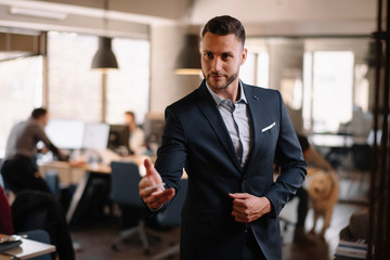 Fototapeta premium Businessman giving visit card. Handsome businessman in office 