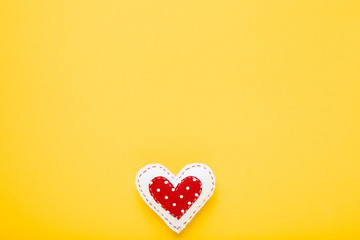 Fabric heart on yellow background