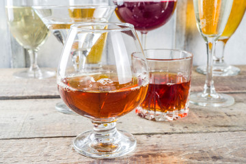 Selection of different alcoholic drinks - beer, red white wine, martini, champagne, cognac, whiskey...