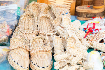 Souvenir bast shoes woven from bast. Old traditional Russian shoes