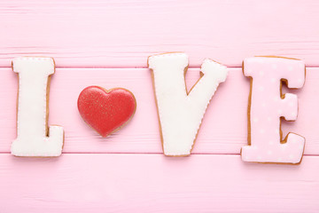 Word Love by cookies on pink wooden table