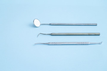 Closeup of dental equipmet laying on blue background