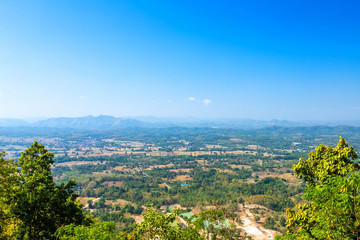 Fototapeta na wymiar Beautiful panoramic view green forest mountain range Phu Thok Park in Loei province,Thailand, blue sky background texture with white clouds