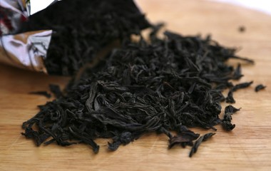 Large sheet of black tea poured on a table from a package