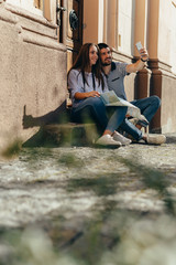 Fototapeta premium romantic couple on touristic tour in strange city