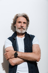 Portrait of a handsome stylish mature man wearing a vest