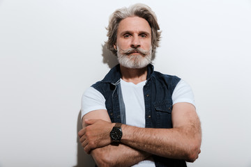 Portrait of a handsome stylish mature man wearing a vest