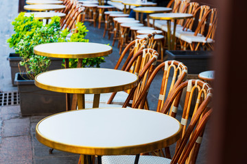Street view of a coffee terrace with tables and chairs, Paris, France