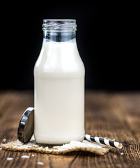 Vintage wooden table with Rice Milk (selective focus; close-up shot)