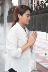 Religious Asian buddhist woman praying. Female buddhist disciple meditating, chanting mantra with...