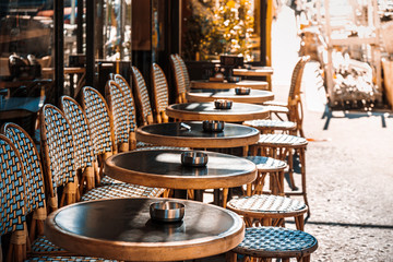 Street view of a coffee terrace with tables and chairs, Paris, France