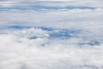 Clouds, sky and ground, looking from the plane.