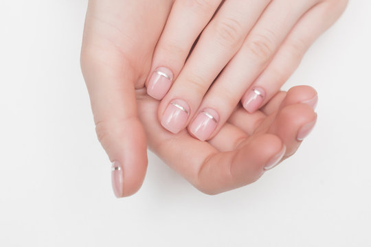 woman hands and nails pink french