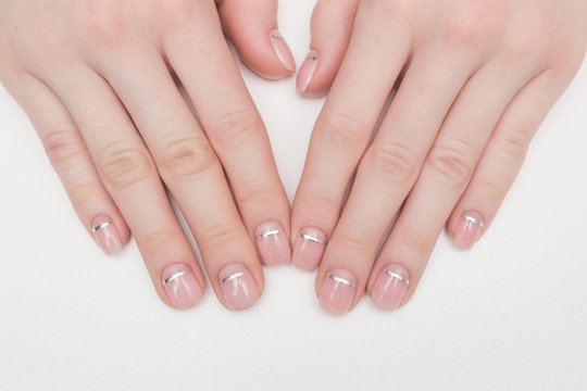 woman hands and nails pink french