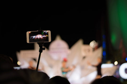 Closeup of smartphone recording video for concert.