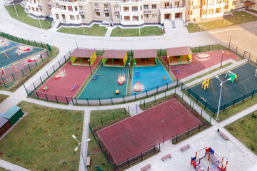 Fototapeta na wymiar Real estate low-rise construction building exterior and children playground in new residential area. Urban development concept image
